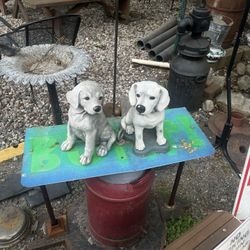 Two concrete dogs 