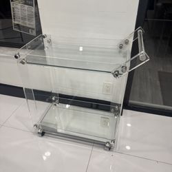 Vintage -style rolling bar cart constructed from clear lucite w/glass shelves - 29” x 15” x 32”