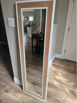 Pottery barn, mirror, and bulletin board that surrounds it