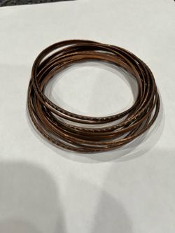 Vintage 1970’s copper entwined 12 bangles.  Six have a design.  Size approximately 3 inches wide.  Smoke free home