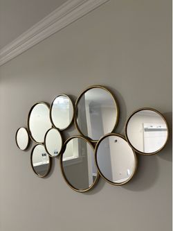 Gold metal framed round bubble cluster wall mirror.