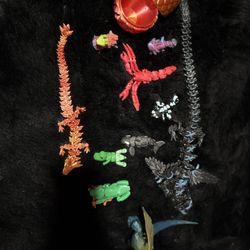 pack of 3D printed objects, containing five  dragons, one axolotl, one whale one dinosaur one frog one lobster one llama from Fortnite one eg
