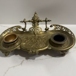 antique brass double inkwell, likely in a Victorian or Baroque style.  