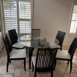 Round black dining table with six chairs