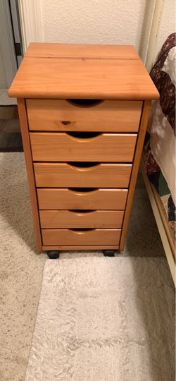 Like NEW Adeptus 6-Drawer Solid Wood Roll Cart in medium pine, featuring six stacked drawers with cutout handles and small rolling caster wheels.