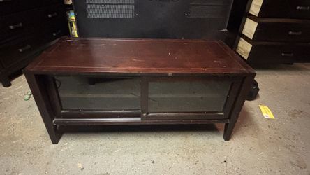 Wooden media center with glass doors