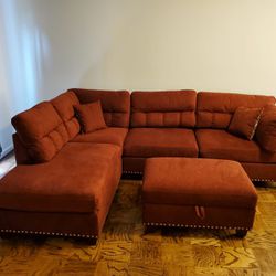 Red Velvet like Sectional Sofa with storage ottoman and 2 accent pillows. 