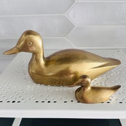 Set of 2 vintage solid brass Ducks.  Large one is 9” long x 4” tall and small one is 3 1/2” long x 1 3/4” tall  Both have overall light natural patina