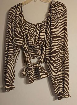 A zebra brown  and tan long sleeve blouse with  tie