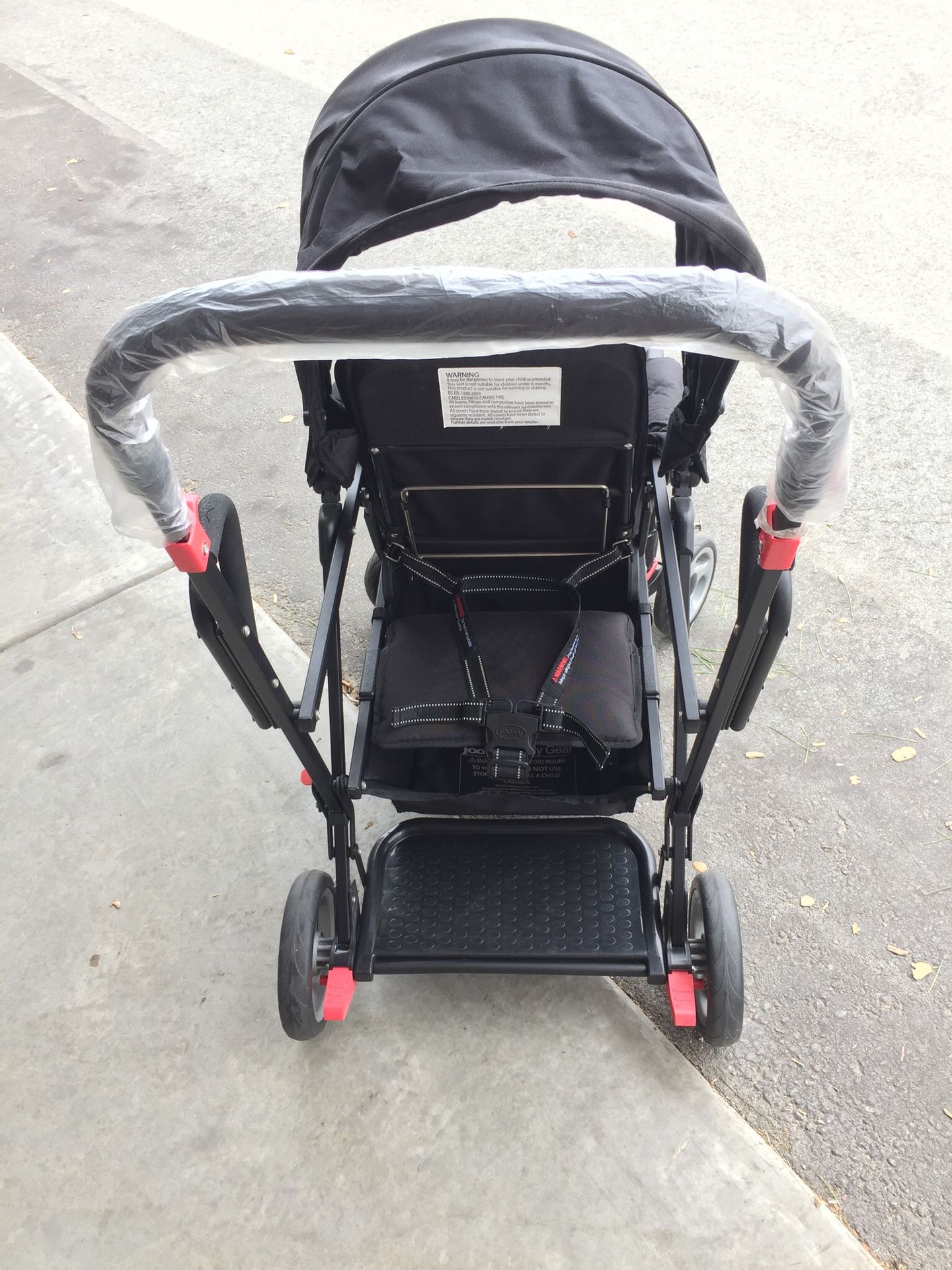 Joovy Caboose Ultralight Sit and Stand Double Stroller with rain cover