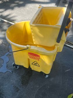 Used mop bucket with mop ringer