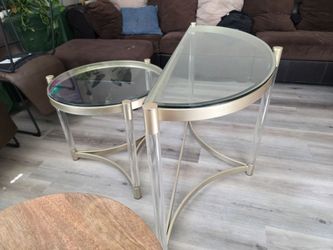 glass-topped tables with clear acrylic legs and metal accents