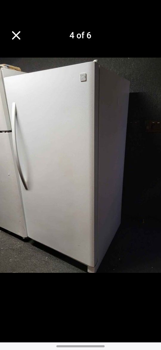 Freezer. Small fridge China cabinet with glass shelves and light, Couch. End tables.