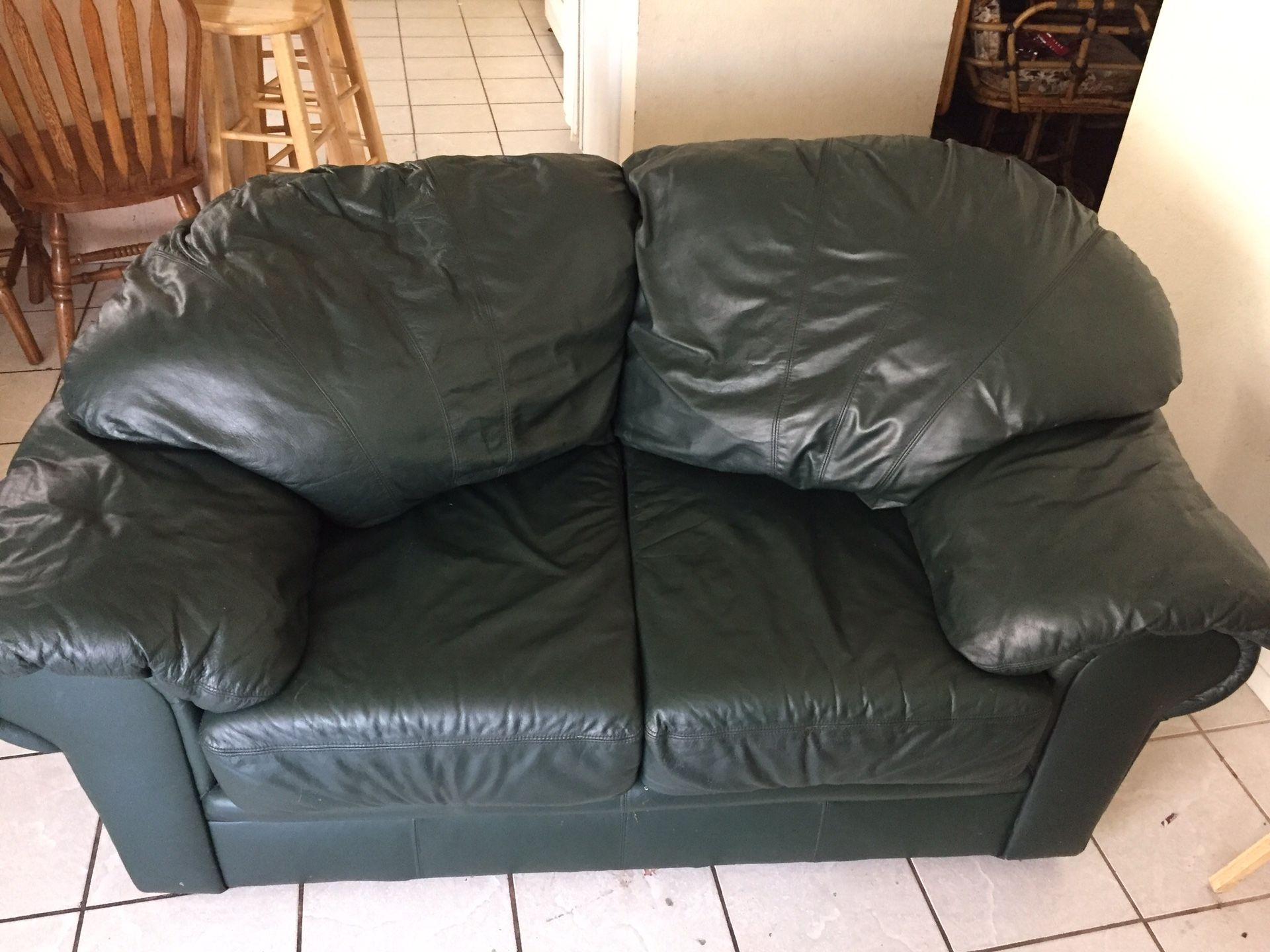 Hunter green leather couch and love seat