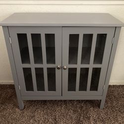Gray Cabinet With Shelves And Windows