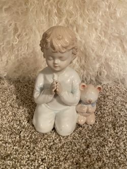 Praying boy figurine
