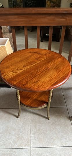 Solid wood two-tier round side table.
