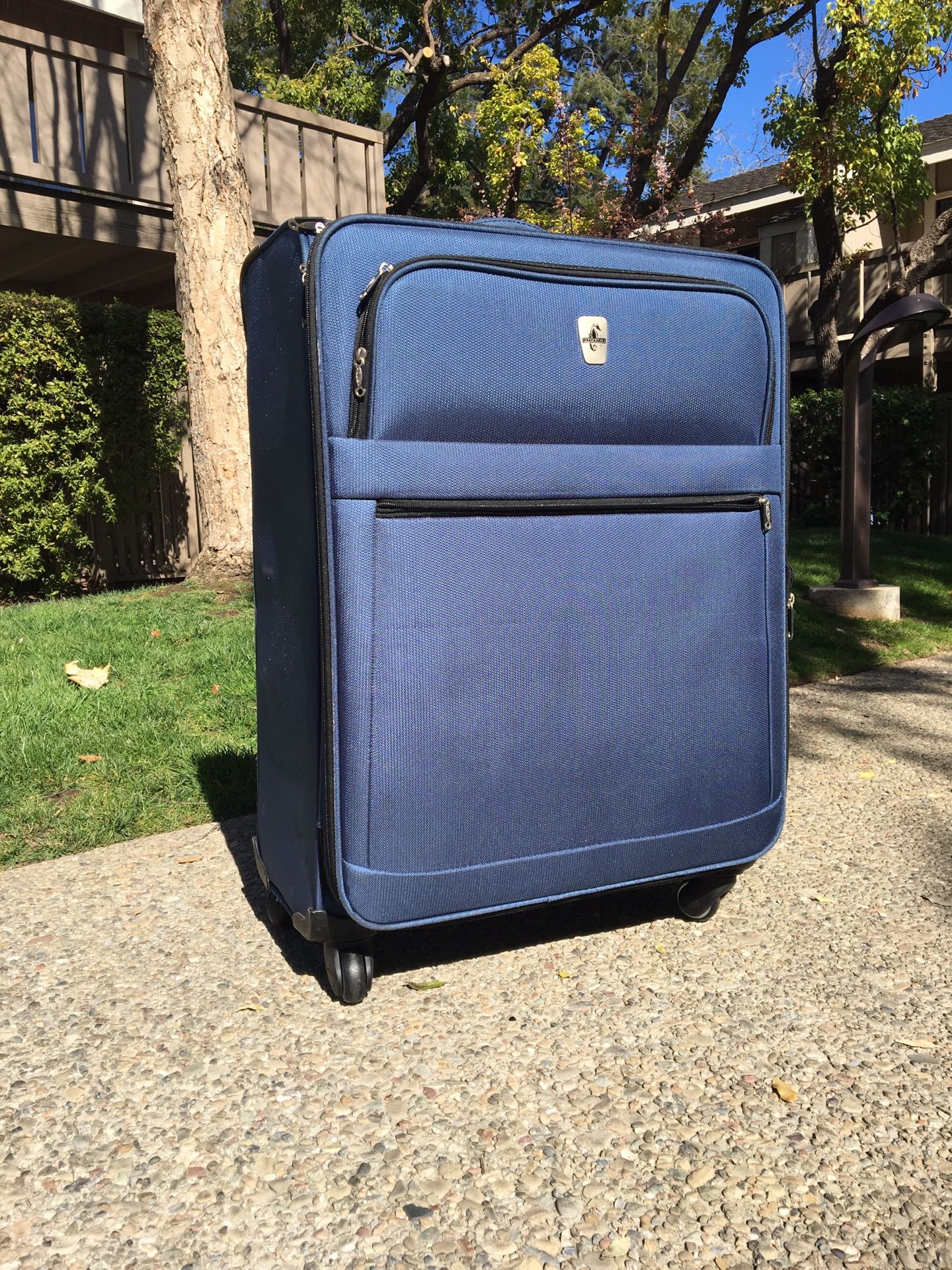 Large blue luggage suitcase with 4 wheels