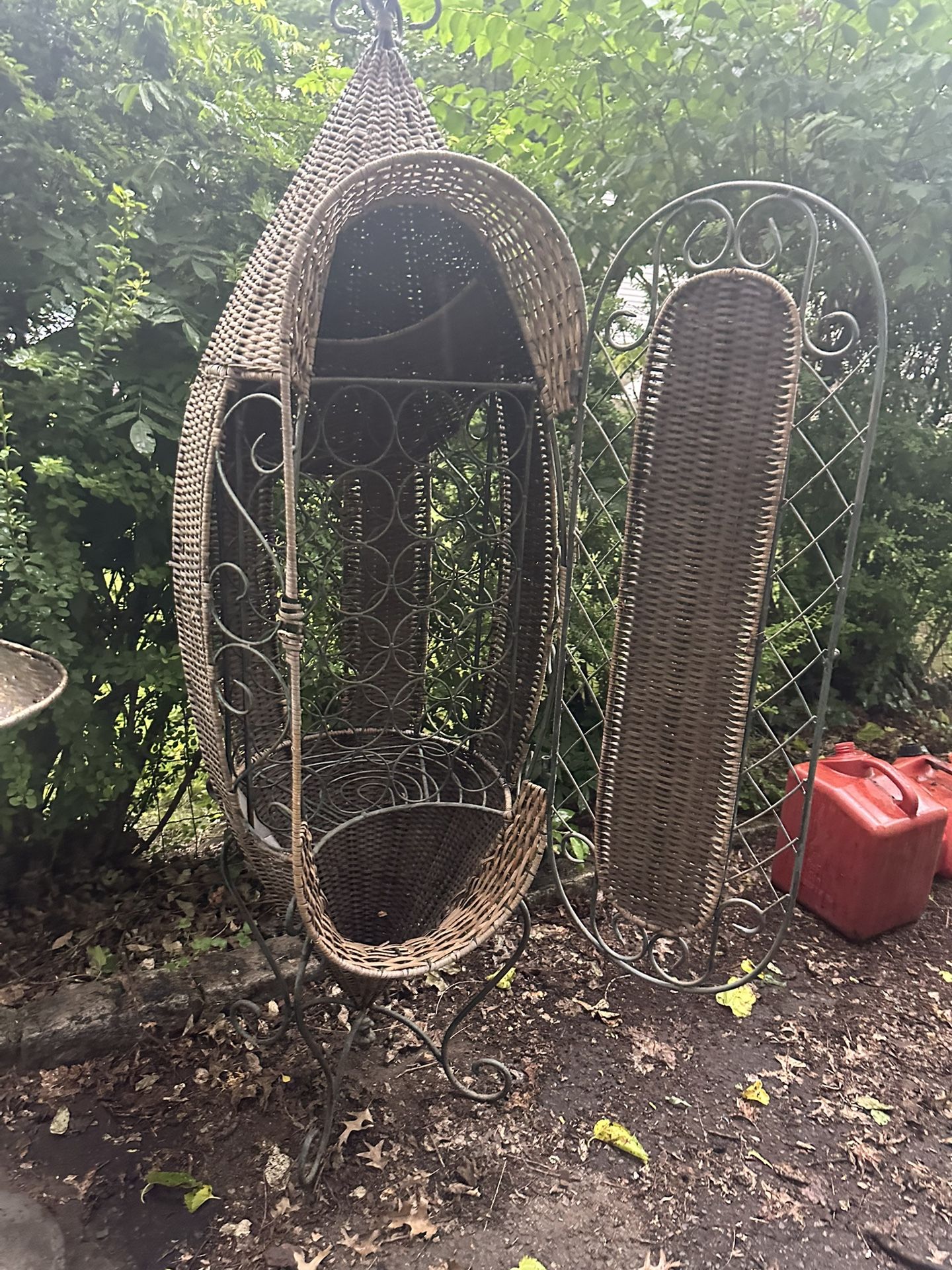 Unique wicker hanging chair with metal stand.