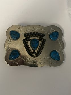 vintage 1980s Southwest-style belt buckle is constructed from silver-plated metal and features faux turquoise stones. 