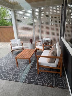 Outdoor patio furniture with cushions and rug