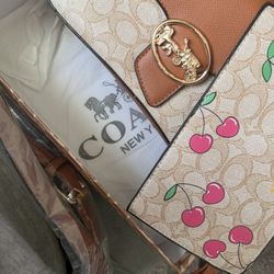 Coach women’s beige cherry bag/wallet set