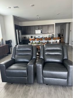 Brand new genuine leather. Set of 2 black leather recliners. Retail was $1600 for both.