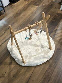 wooden baby gym with toys