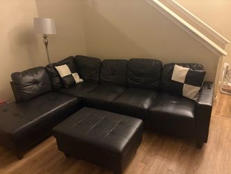 Black leather sectional sofa with ottoman”.