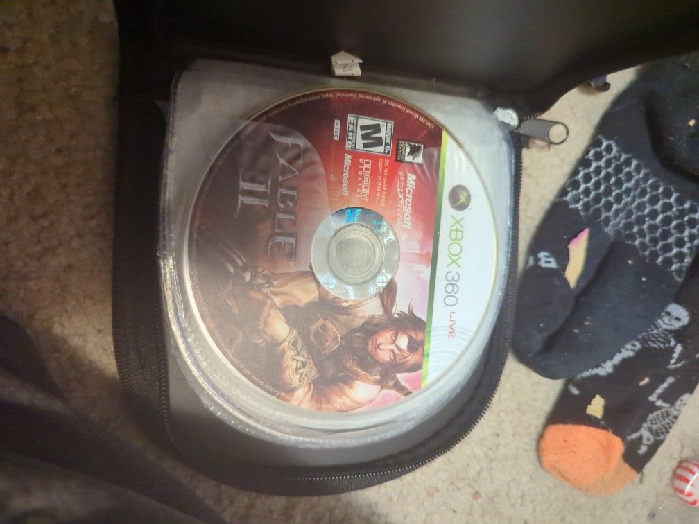 Case Of DVD's And Two Xbox 360 Games.