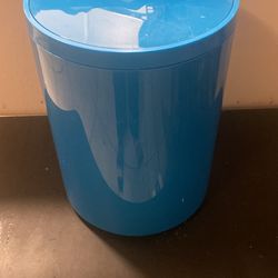 small blue trash bin