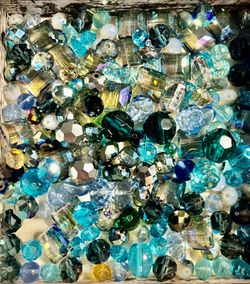 Vibrant aqua and teal bead mix adds sparkle to craft and decor projects. Includes assorted shapes and finishes for layered texture and shine. Perfect