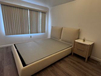A like-new beige queen-size bed frame （and a matching bedside table)