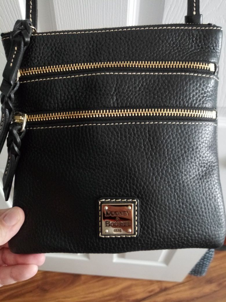Authentic Dooney & Bourke black triple zip crossbody purse NWT..Makes a great gift.