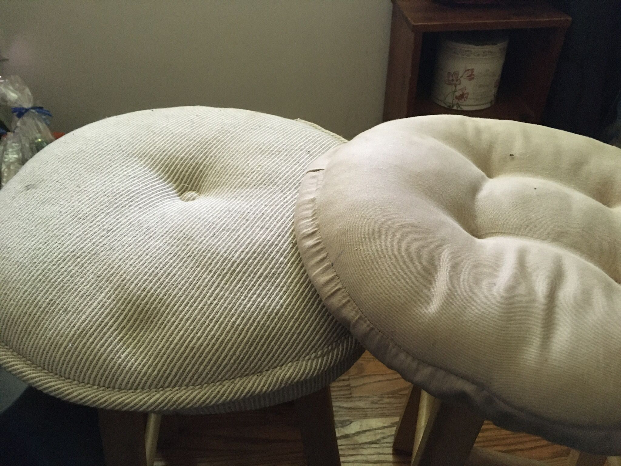 2 Beige Stool Cushions. One Is Striped And One Solid But They Match