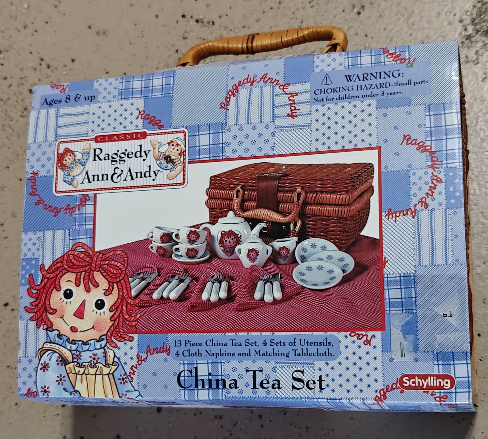 Raggedy Ann & Andy Classic 13 Piece China Tea Set packed inside a wicker picnic hamper.