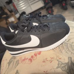 Nike Cortez sneakers in a classic black and white colorway.