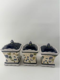 Set of 3 Capriware ceramic kitchen canisters featuring a purple grape and blackberry pattern with navy lids.