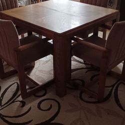 Dining table with five chairs and a leaf