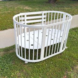 Oval wooden baby crib