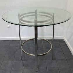 Brushed steel pub table with glass top.