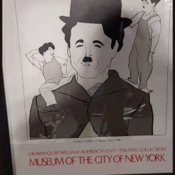 VERY RARE ART WORK. This image is a framed print featuring a caricature of Charlie Chaplin as the character from his 1936 film "Modern Times