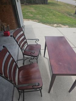 Hardwood table and 2 wrought iron chairs