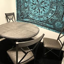 grey round wood table with 3 chairs