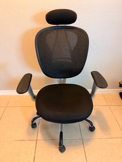 ergonomic mesh office chair with a headrest and padded/adjustable armrests.
