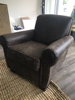 Aged leather armchair and ottoman
