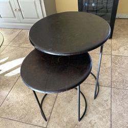 small wooden black tables with metal stands attached
