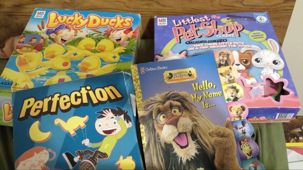Lucky ducks game. Littlest pet shop game. Perfection game and golden book reading activity book.