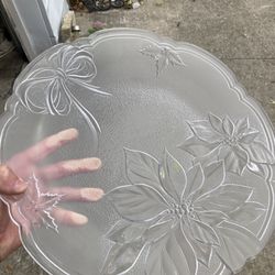 Clear glass plate with floral and bow design.