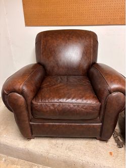 Brown overstuffed leather armchair